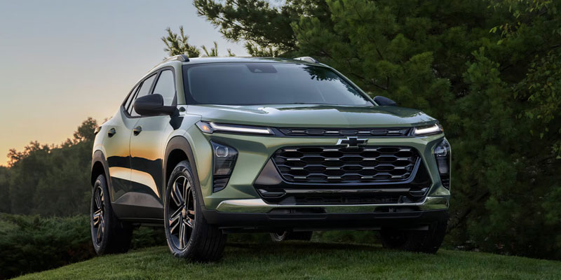 Green Chevrolet Trax parked on a grassy hill.